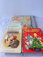 All four books front covers visible