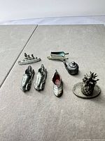 All seven metal tokens arranged on surface