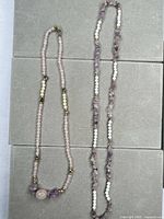 Full view of both stone bead necklaces laid side by side