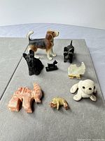 group of eight miniature dog figurines in mixed materials