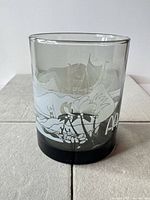 Front view of tumbler showing tropical graphics and black base