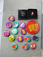 Group shot of all buttons and box laid out