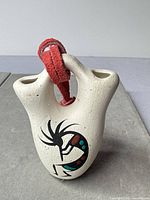 Front view showing Kokopelli design, strap, and overall form