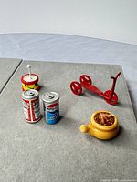 All five miniature items arranged on grey surface