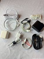 All items laid out to show quantity and variety of cables, adapters and earbuds