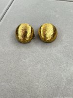 Front view of both gold-tone dome earrings