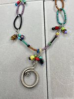 Close-up of spiral pendant and bead charms