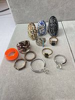 All twelve rings laid out in rows showing fronts and bands