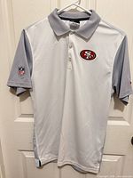 Front view of polo showing logo and color blocking