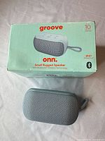 Speaker and box front showing product and branding