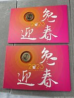 Front of both red envelopes showing coins and design
