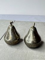 Pair of metal pear shakers front view