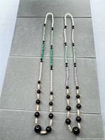 Full view of both necklaces showing complete length and bead pattern