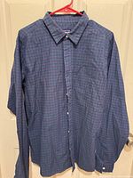 Front view of Patagonia plaid button-up shirt hanging
