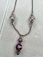 Full view of necklace showing bead stations, chain, and pendant drop
