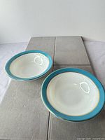 Two Pyrex milk glass bowls showing full view