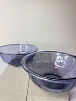 Two purple glass mixing bowls side by side