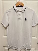 Front view of white Ralph Lauren polo shirt on hanger