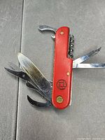 Multitool front view with several blades opened