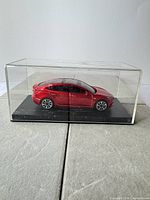 Model car inside acrylic cover on black base