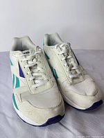 Front view of both sneakers showing laces, toe boxes, color scheme