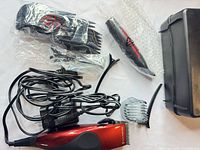 Group view of clipper, combs, trimmer, cords, case
