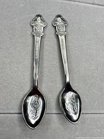 Full view of two Rolex Bucherer Lucerne souvenir spoons
