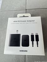 Front of sealed box showing 45 W PD Power Adapter contents