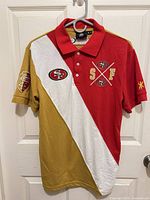 Full front view of polo showing color blocking and embroidered logos
