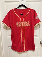 Full front view of jersey on hanger