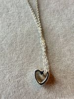 Necklace with heart pendant laid flat