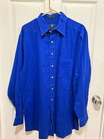 Front view of blue button-up shirt on hanger