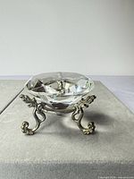 Crystal bowl on ornate metal stand, full view