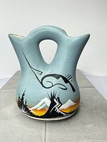 front view of vase showing double spouts, handle and painted design