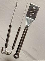 Spatula and tongs full view on white background