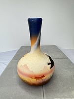 Full front view of vase displaying painted Southwestern wildlife design