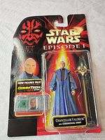 Front view of sealed Episode I card showing figure, staff, CommTech chip