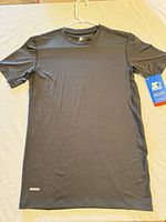 Full view of black Starter Dri-Star performance tee on hanger