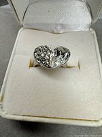 Ring in box showing heart design with rhinestone and crystal halves