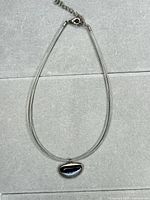 Full view of multi-strand necklace with pendant and clasp