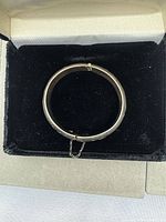 Full view of closed sterling bangle in box