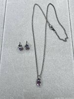 Full view of necklace, pendant and earrings
