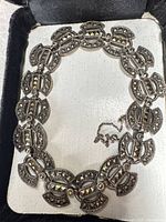 Front view of sterling silver marcasite link bracelet inside presentation box