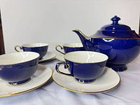 Full tea set showing teapot, four cups, four saucers
