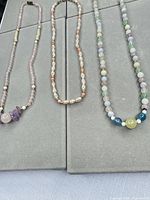 Overview showing the three necklaces laid out