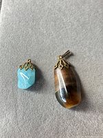 Both pendants side by side showing size and caps