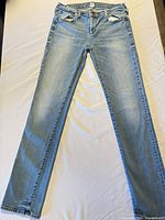 Full view of jeans front side laid flat