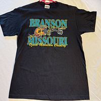Full front view of black T-shirt with Branson Missouri guitar graphic