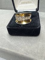 Front view of two-tone sterling silver gold-plated ring with channel-set cubic zirconia in presentation box