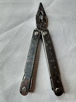 Multitool opened to plier position showing ruler markings